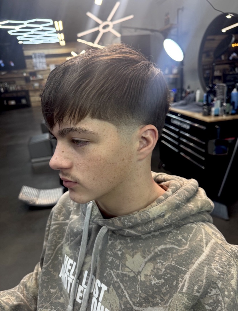 Low taper fade with a textured fringe