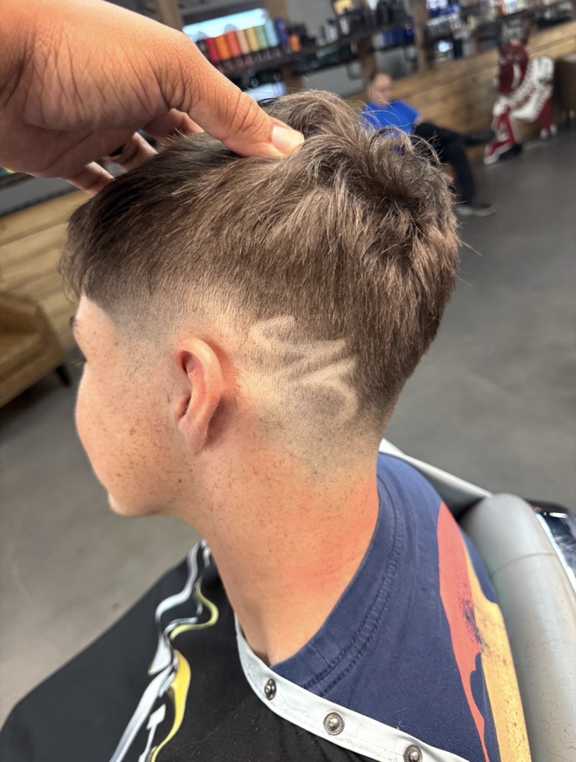 Mid fade with a freehand razor design
